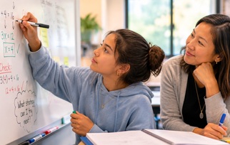 Student working through a challenging problem with support from a teacher